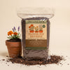 OrganiLock Flower Pot Refresh bag beside a terracotta pot of marigolds and lavender